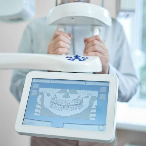 Patient of a dental clinic getting a panoramic dental x-ray Patient of a dental clinic getting a panoramic dental x-ray