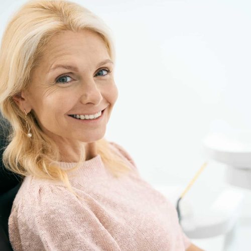 Pretty patient looking with smile in dental clinic Pretty patient looking with smile in dental clinic