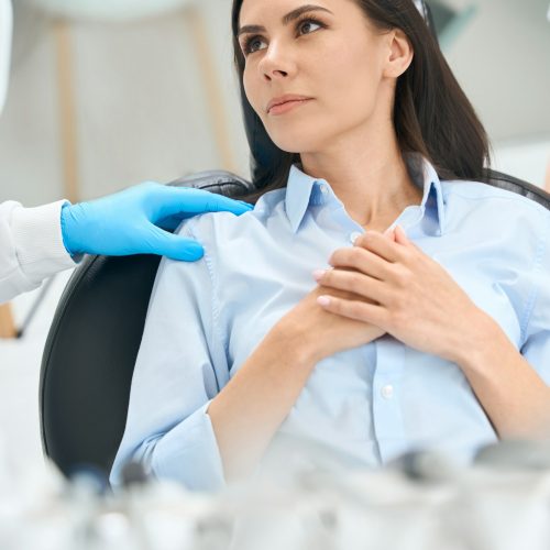 Woman feeling nervous sitting in comfortable chair at the doctor's appointment