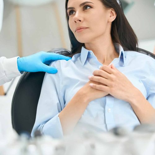 Woman feeling nervous sitting in comfortable chair at the doctor’s appointment Woman feeling nervous sitting in comfortable chair at the doctor's appointment